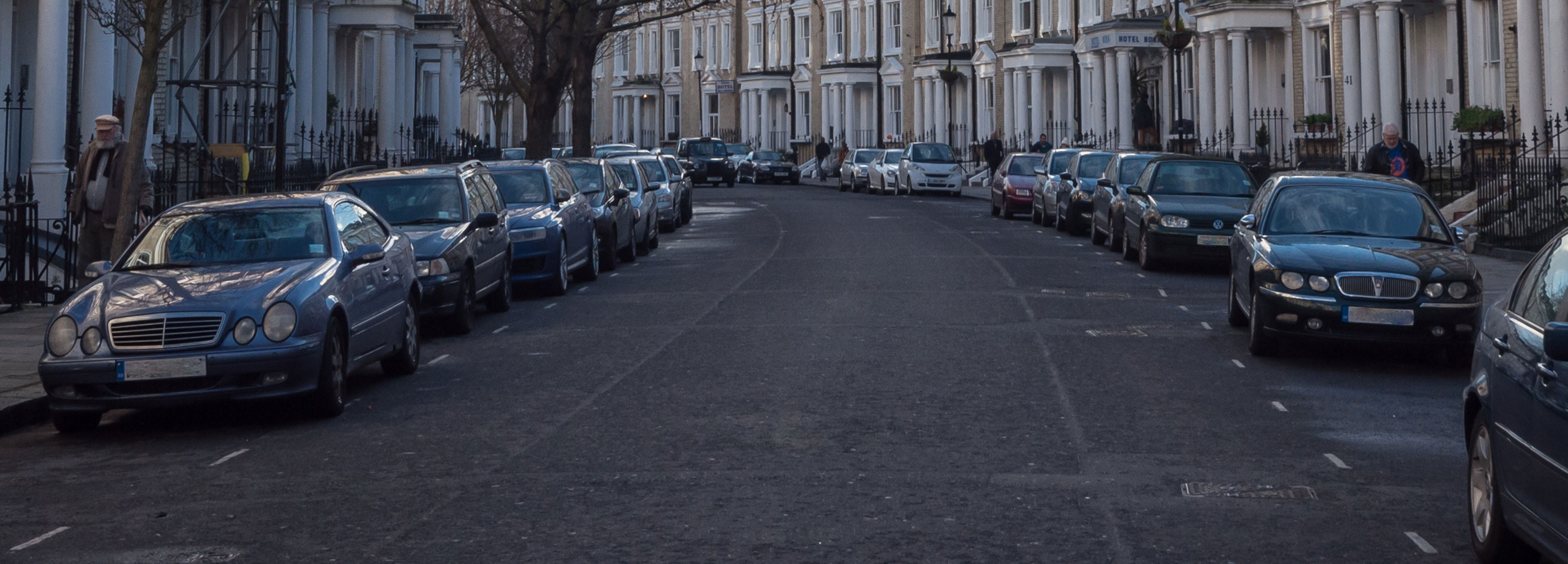 Cars parked along busy street